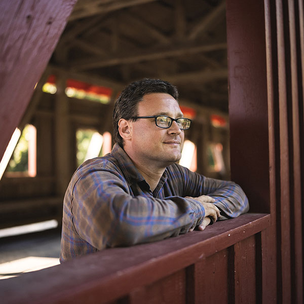 Man Posing On Wooden Ledge