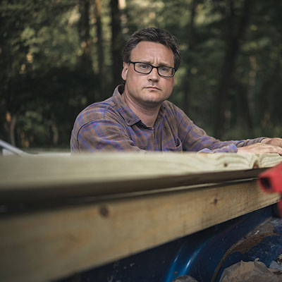 Man Posing With Lumber